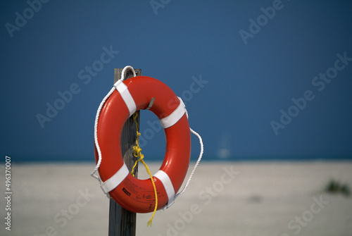 Life preserver hanging on a wooden post photo