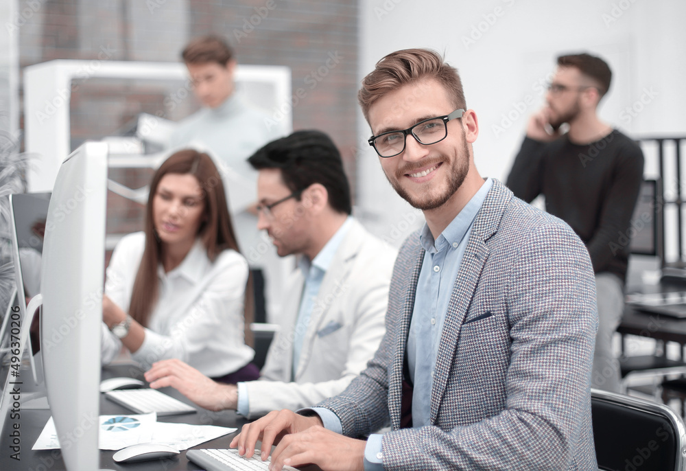 smiling businessman in the workplace smiling businessman in the workplace