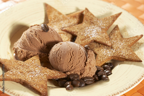High angle view of a chocolate ice cream with bunuelos and coffee beans on a plate photo
