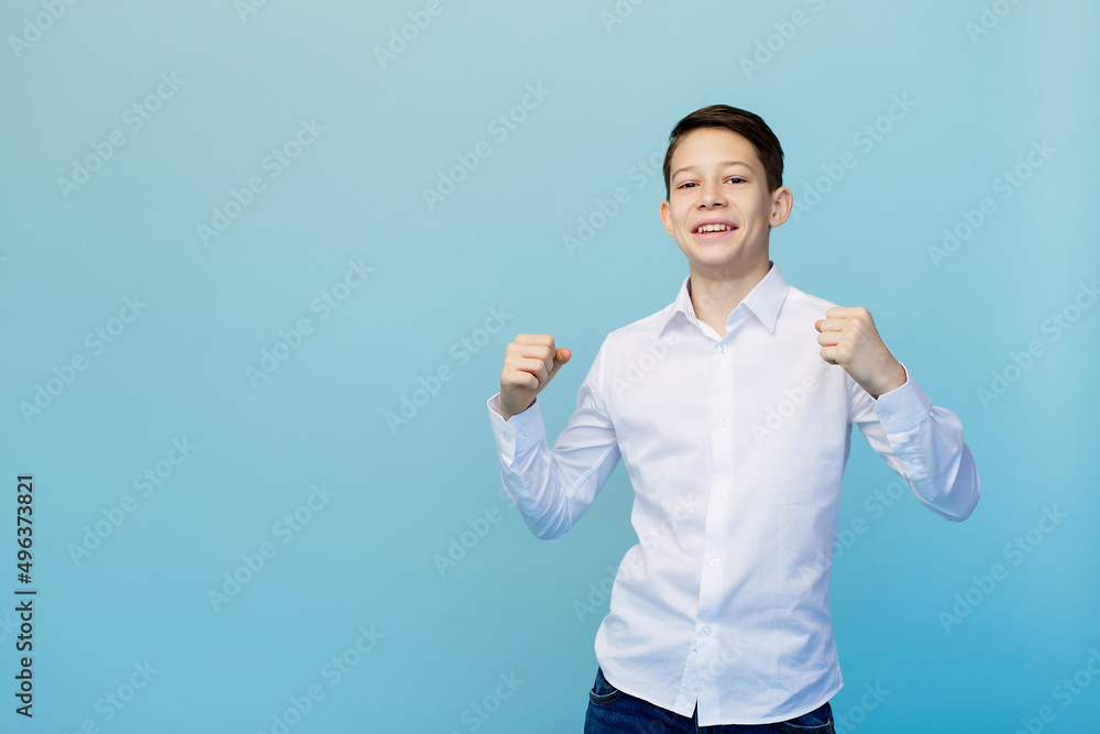 A happy boy on a blue background. There is a place for the inscription. A happy boy on a blue background. There is a place for the inscription.