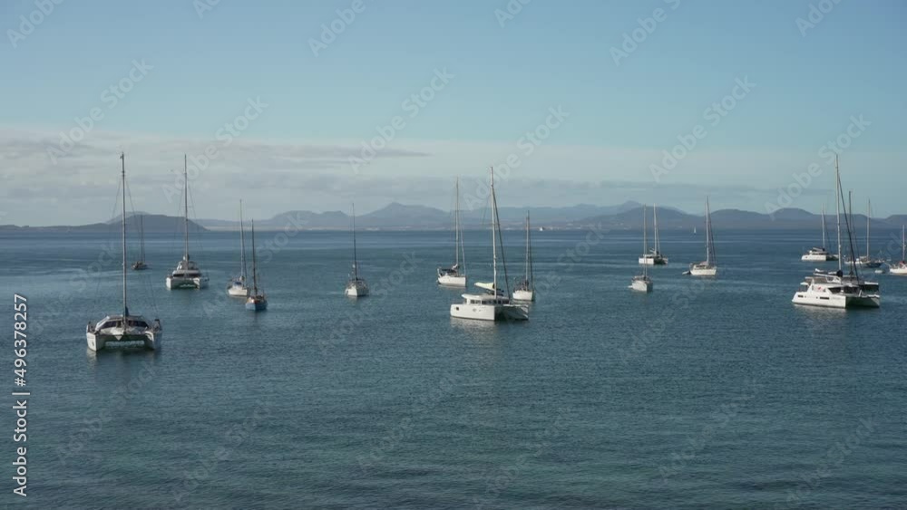 Yachts on the water with Fuerteventura in background in the morning, Playa Blanca, Lanzarote, Canary Islands, Spain Yachts on the water with Fuerteventura in background in the morning, Playa Blanca, Lanzarote, Canary Islands, Spain
