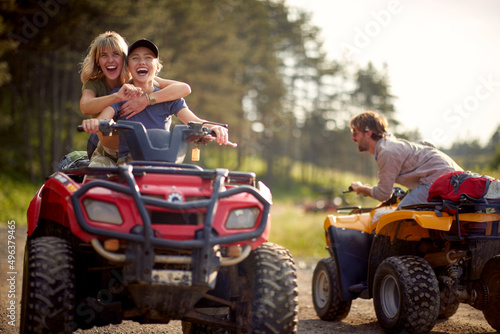 A group of happy friends riding quads on the mountain. Riding, friendship, nature, activity photo