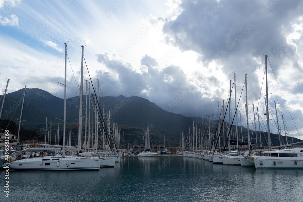 Luxury boats and yachts in marina. Maritime. Cloudy sky background.