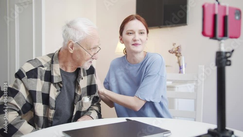 A girl interviews an elderly man with glasses on stream