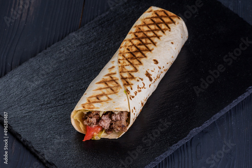 Doner with beef on a black slate tray