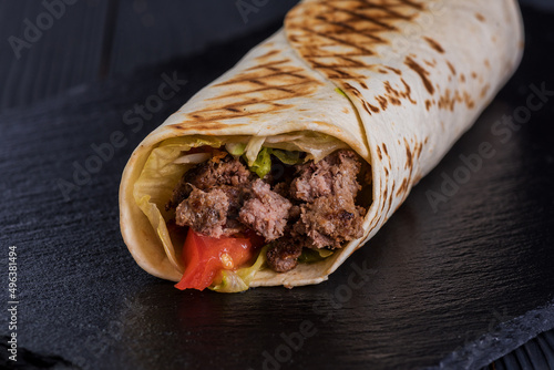 Doner with beef on a black slate tray