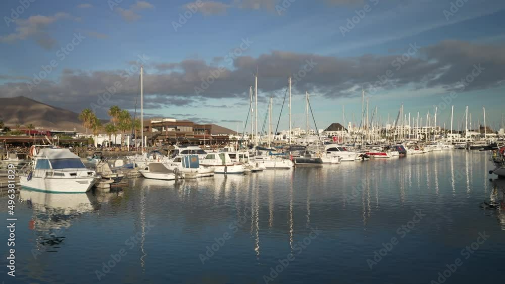 Restaurants and boats in Rubicon Marina and mountains in background, Playa Blanca, Lanzarote, Canary Islands, Spain Restaurants and boats in Rubicon Marina and mountains in background, Playa Blanca, Lanzarote, Canary Islands, Spain