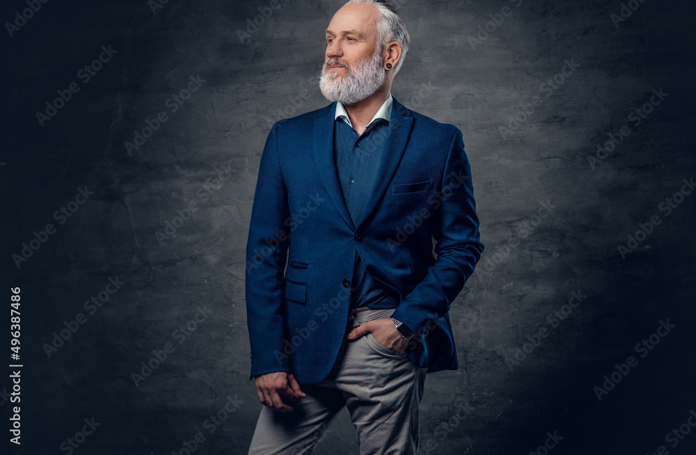 Aged handsome man dressed in gray pants and dark blue jacket Aged handsome man dressed in gray pants and dark blue jacket