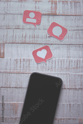 Social Media Concept Smart Phone with Paper Cut Icons in Speech Bubble