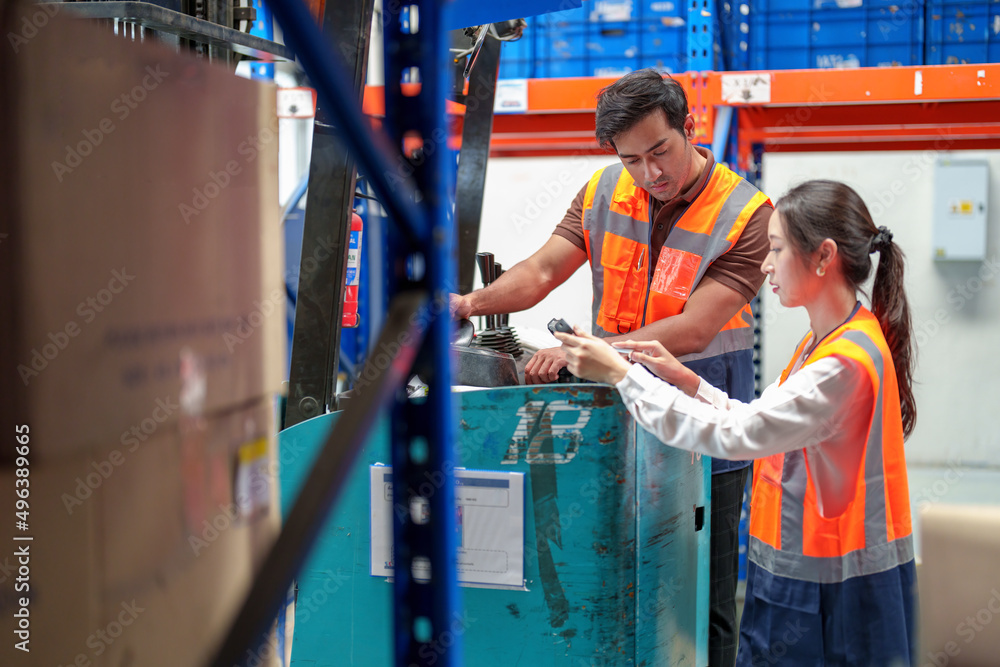 Warehouse workers discussing shipping schedule. Warehouse workers discussing shipping schedule.