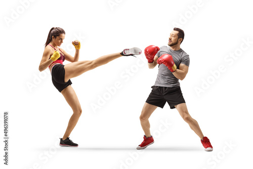 Young man and woman exercising kick box