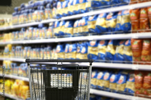 choosing a dairy products at supermarket.empty grocery cart in an empty supermarket