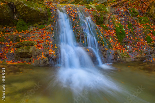 small mountain river with waterfall in mountain canyon, autumn outdoor mountain scene