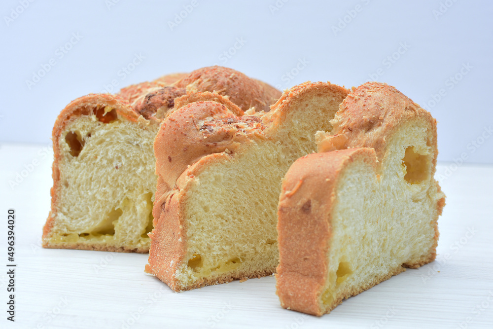 Big bread with cheese, grated parmesa cheese on white wooden background Big bread with cheese, grated parmesa cheese on white wooden background