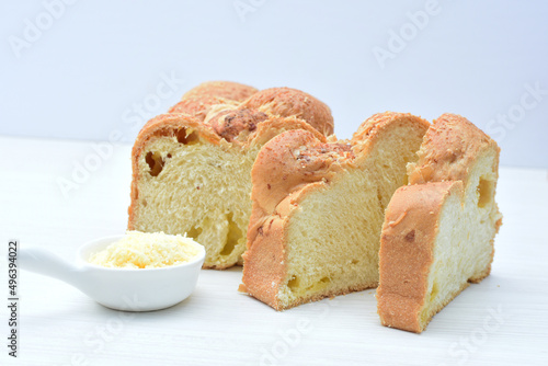 Big bread with cheese, grated parmesa cheese on white wooden background