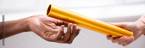 Passing Golden Relay Baton To Other Person
