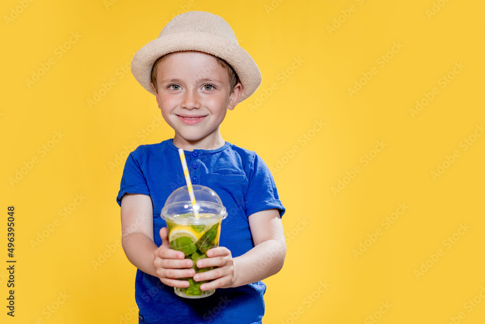 Summer refreshment. Cold beverage. Little boy with plastic cup of fresh lemonade Summer refreshment. Cold beverage. Little boy with plastic cup of fresh lemonade