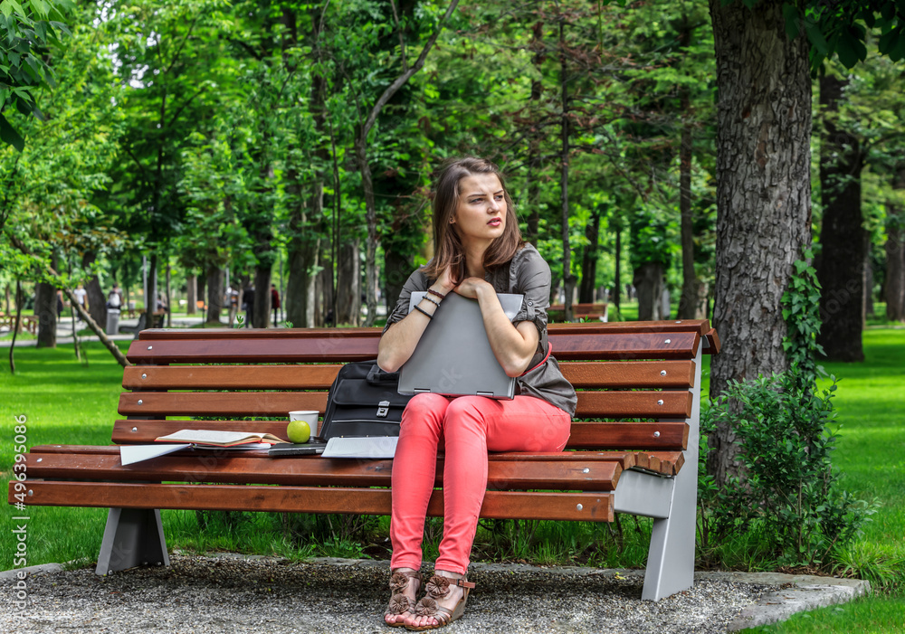 Young Woman with a Laptop in the Park Young Woman with a Laptop in the Park