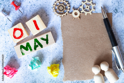 May 1st. Image of may 1 wooden calendar on the table. Spring day, empty space for text. International Workers' Day.