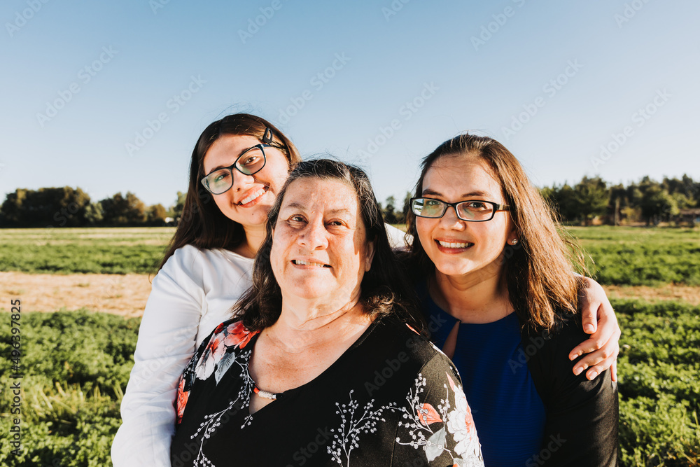 Female Family smiling and hugging in the field on a sunny day afternoon. Mothers day. Female Family smiling and hugging in the field on a sunny day afternoon. Mothers day.