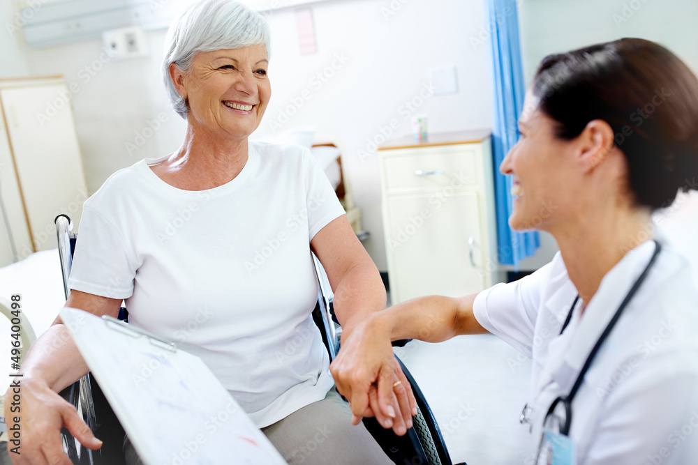 Making it through with a helping hand. Shot of a beautiful young doctor giving her senior patient good news. Making it through with a helping hand. Shot of a beautiful young doctor giving her senior patient good news.