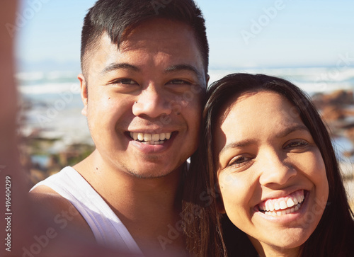 Selfies by the seaside. Selfie of a happy young couple by the sea together.