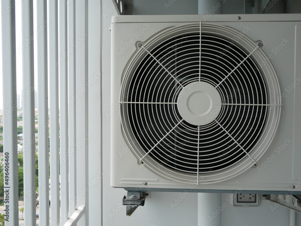 closeup of air conditioner compressor outside building.
closeup of air conditioner compressor outside building.