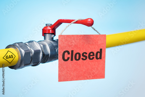 Photos Yellow gas pipe with a valve and  CLOSED sign on blue background