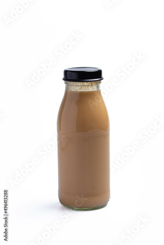 Clear glass bottle with brown water drink on white background. Isolated image.