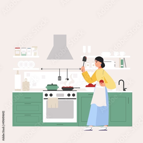The woman is cooking in the kitchen. Apron for cooking. Cozy kitchen with appliances and utensils.