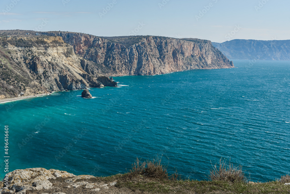 View of Crimean rugged rocky shore with Saint George Monastery and rock of Holy Apparition from Cape Fiolent in spring. Sevastopol, Crimea