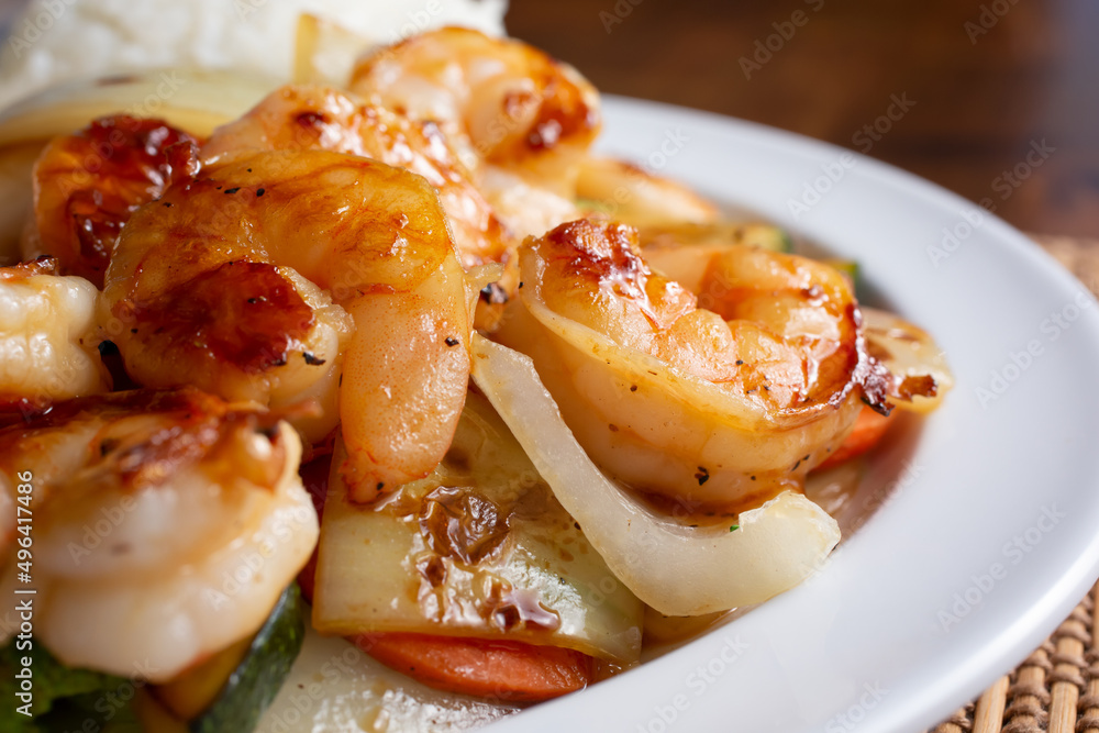 A closeup view of a plate of teriyaki shrimp. A closeup view of a plate of teriyaki shrimp.
