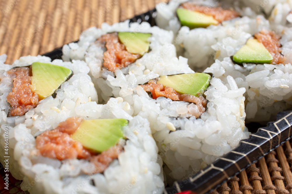 A view of a tray of spicy tuna roll. A view of a tray of spicy tuna roll.