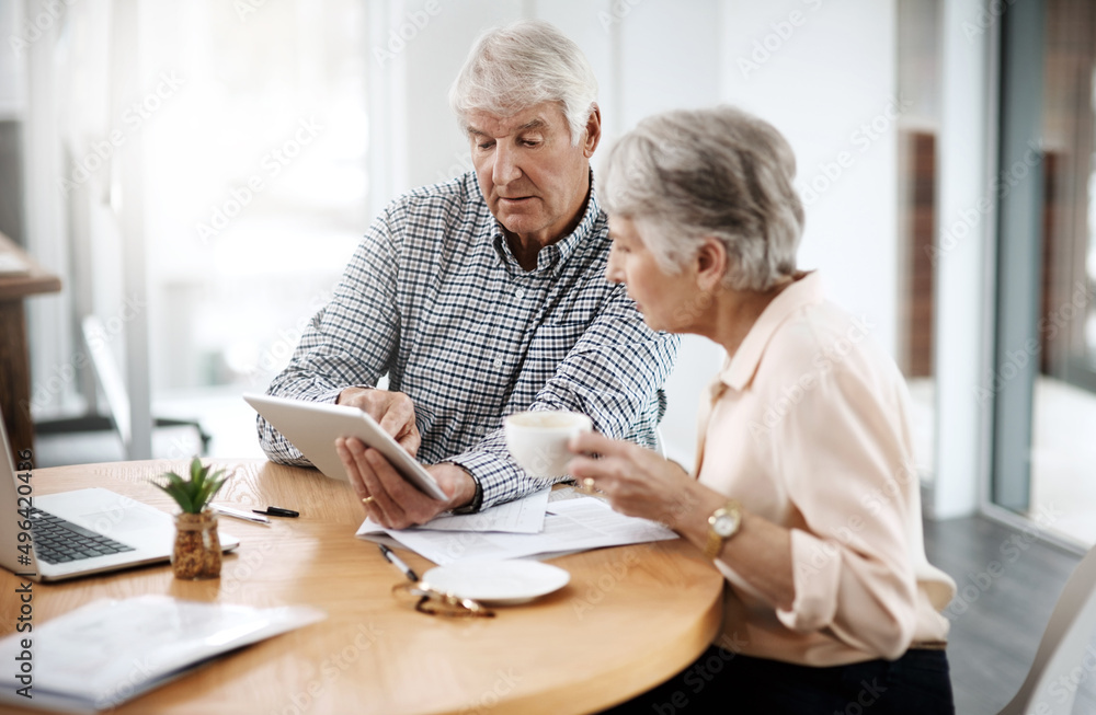 Making sound financial decisions. High angle shot of a senior couple working on their finances at home. Making sound financial decisions. High angle shot of a senior couple working on their finances at home.