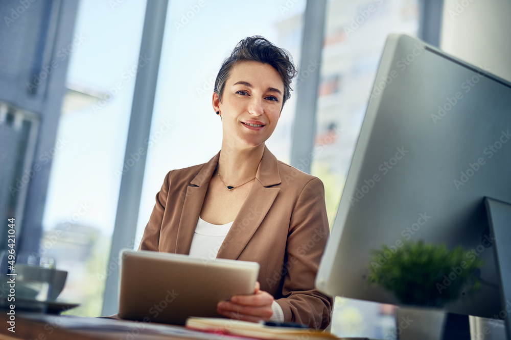 Im just determined to get the job done. Portrait of a businesswoman working on a digital tablet in an office. Im just determined to get the job done. Portrait of a businesswoman working on a digital tablet in an office.