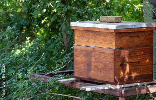 A Langstroth beehive isolated in a quiet spot in a field