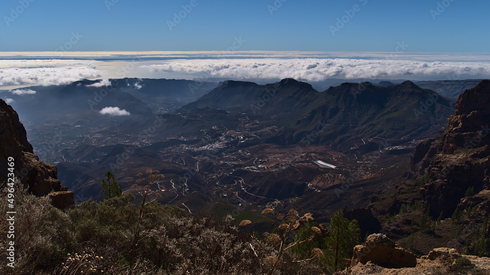 Panoramic view over the central mountains of island Gran Canaria, Canary Islands, Spain with village San Bartolome de Tirajana on sunny day in winter.