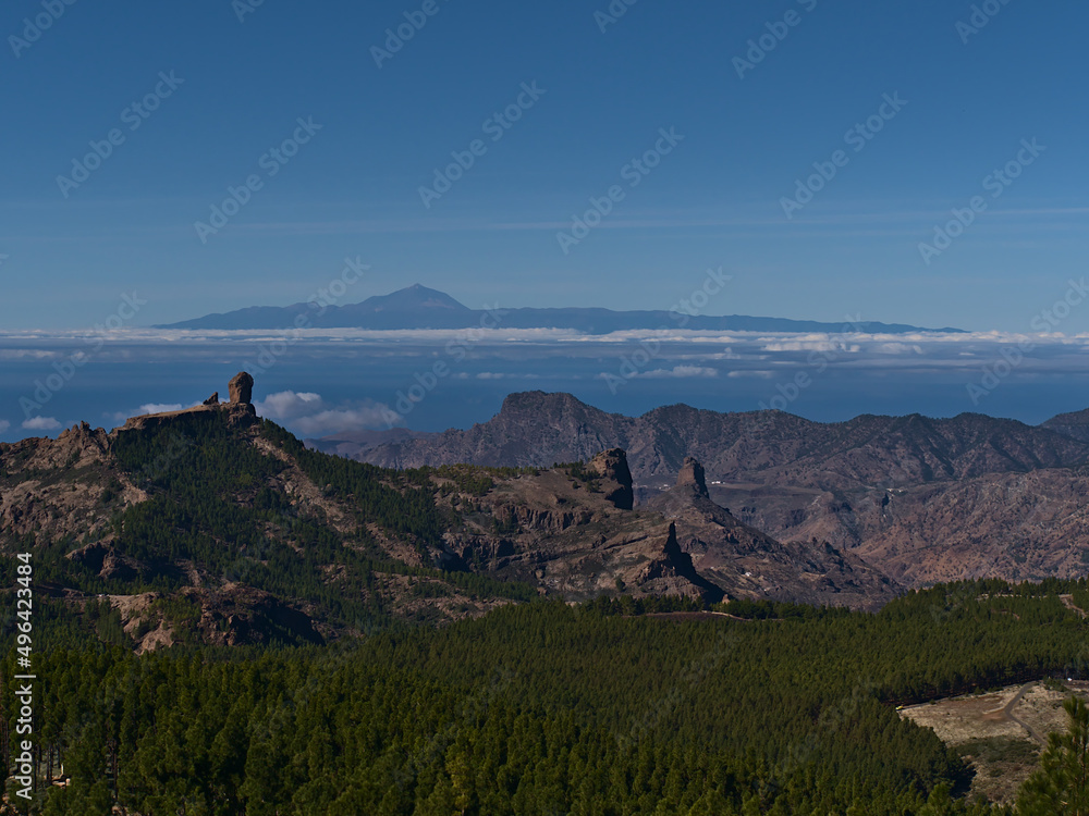 View over the central mountains of Gran Canaria, Canary Islands, Spain with famous rock formation Roque Nublo and adjacent island Tenerife and Teide.