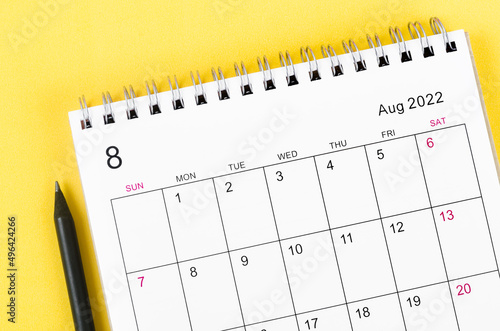 August 2022 desk calendar on yellow background.