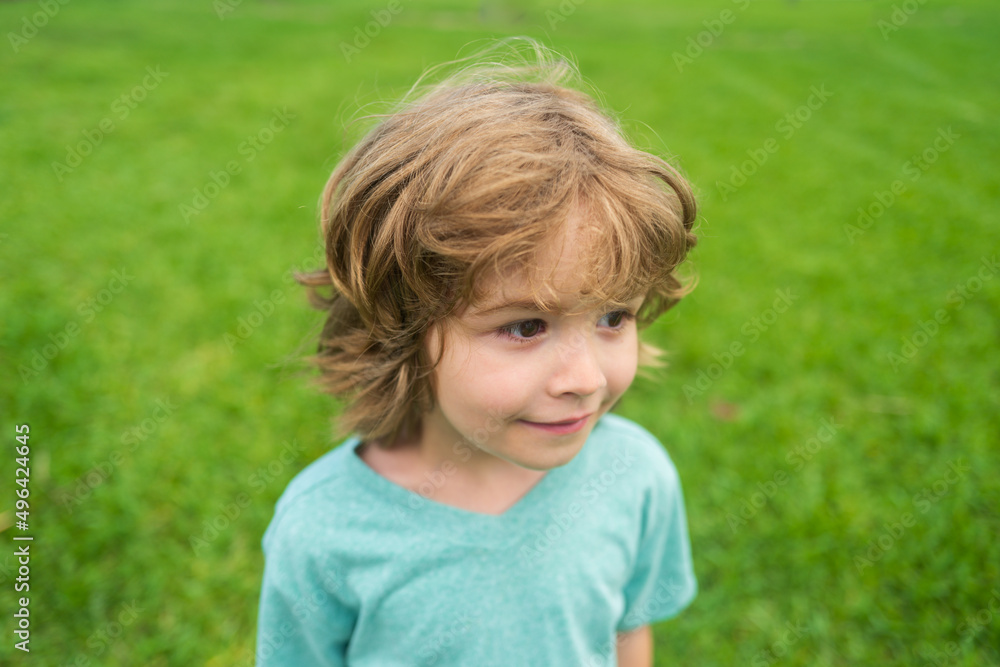 Summer kids portrait. Closeup face of cute smiling spring child. Kid emotions concept. Portrait of young laughing boy outdoor. Summer kids portrait. Closeup face of cute smiling spring child. Kid emotions concept. Portrait of young laughing boy outdoor.