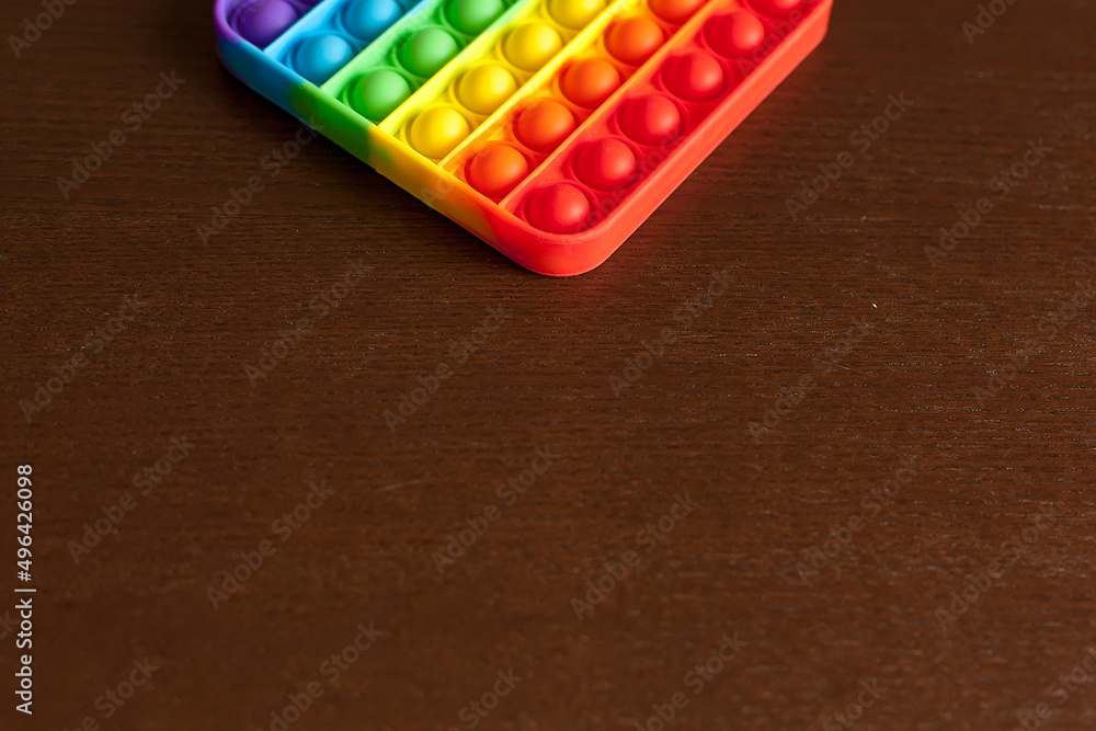 anti-stress sensory toys in children's hands. the kid holds and plays popit the colors of the rainbow, the trend of 2021. development of fine motor skills anti-stress sensory toys in children's hands. the kid holds and plays popit the colors of the rainbow, the trend of 2021. development of fine motor skills