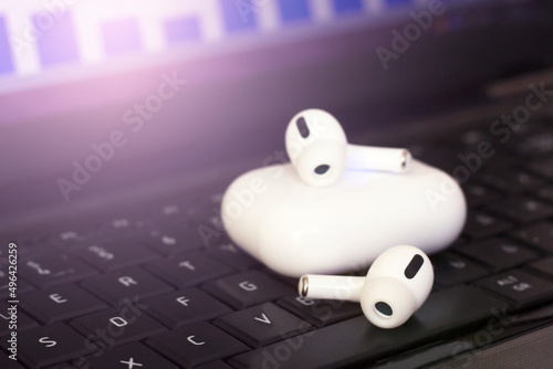 White Wireless headphones on a laptop