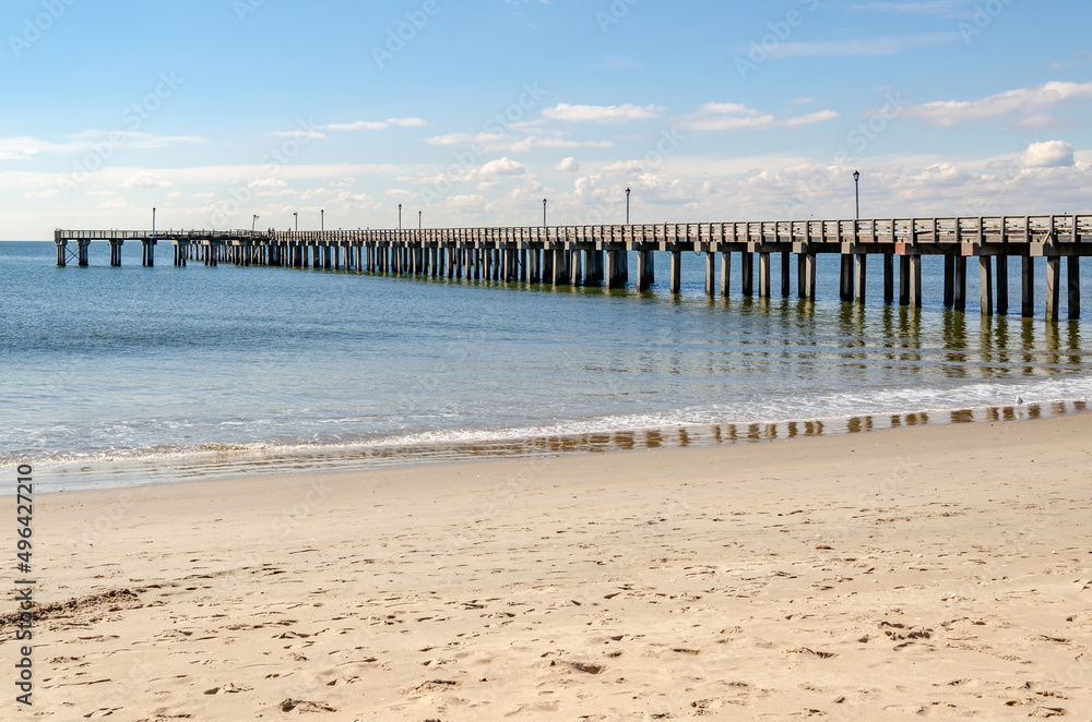 Pat Auletta Steeplechase Pier at Coney island Beach, view from the side, Brooklyn, New York City during winter day with almost clear sky, Ocean in the Background, horizontal