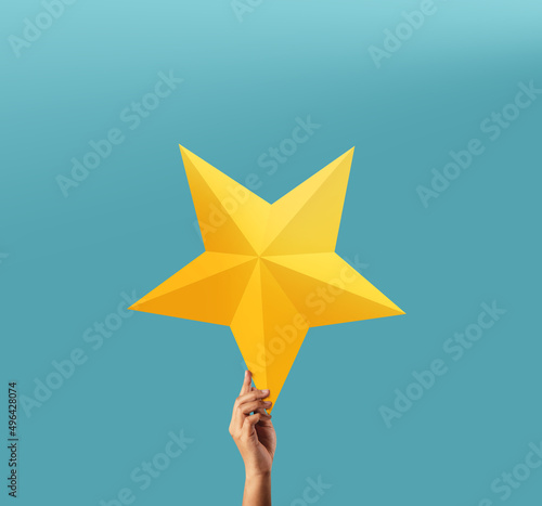 Картината върху платно Successful and Talent Concept, Hand Raise up a Golden Star into the blue Sky