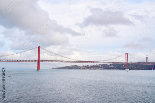 Beautiful landscape with suspension 25 April bridge bridge over the Tagus river in Lisbon, Portugal.