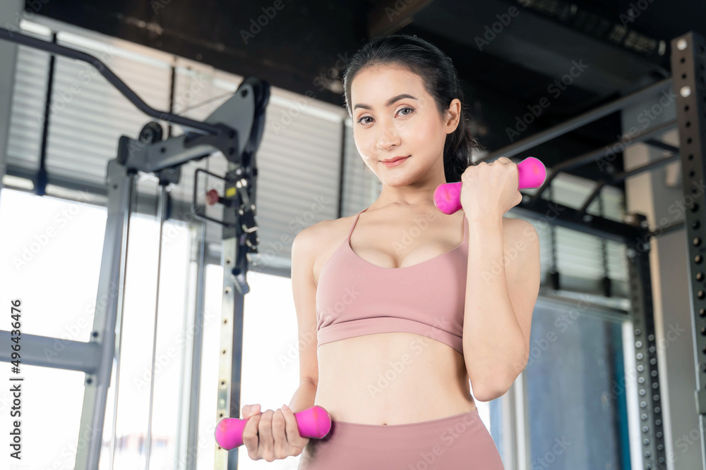 Beautiful fitness woman working push up with dumbbells in a gym fitness room , Asian sexy girl slim body - fitness model concept. Beautiful fitness woman working push up with dumbbells in a gym fitness room , Asian sexy girl slim body - fitness model concept.