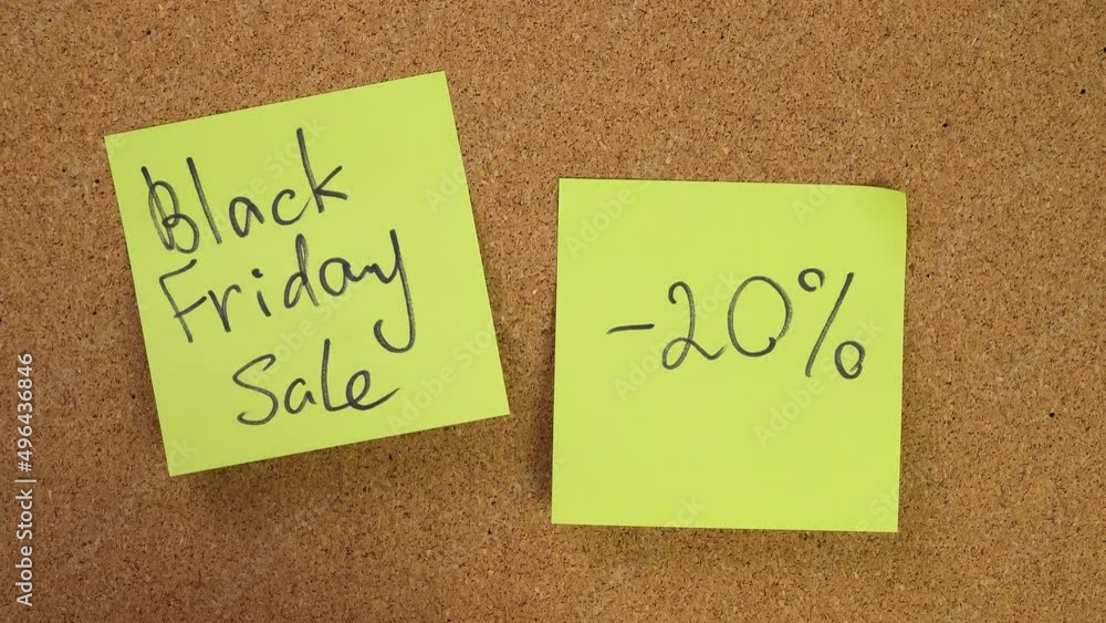 black friday sale. minus 20 percent off discounts. Stick the sticker on the cork board. Top view of note board. Wall of records in the office. Caucasian male hand sticks and unsticks paper. black friday sale. minus 20 percent off discounts. Stick the sticker on the cork board. Top view of note board. Wall of records in the office. Caucasian male hand sticks and unsticks paper.