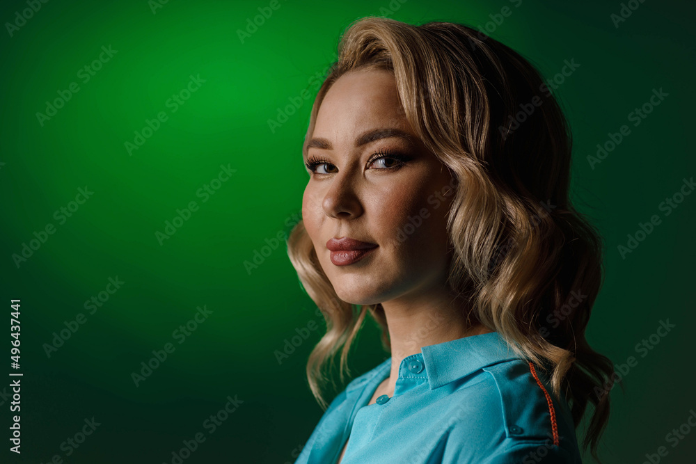 portrait of a girl in a blue dress , shot in a studio on a green background portrait of a girl in a blue dress , shot in a studio on a green background