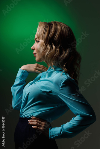 portrait of a girl in a blue dress , shot in a studio on a green background © artem