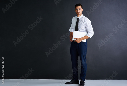 Make way for the next CEO. Studio portrait of a young businessman standing against a black background.